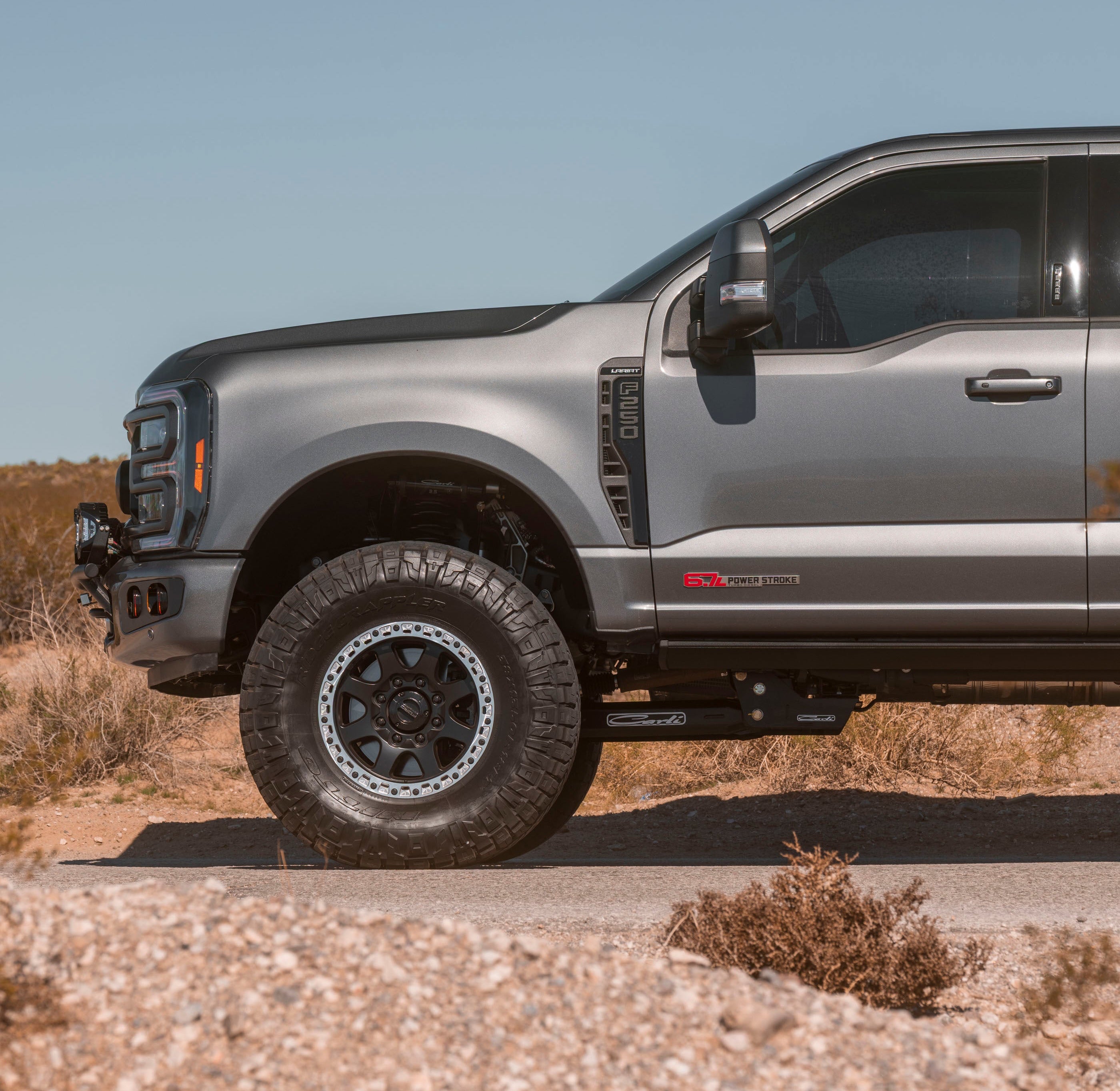 A 2023+ Ford Super Duty leveled on 38" tires with 0 offset 18x9 Foundation 395 HD wheels in black finish with machined OMF rings.