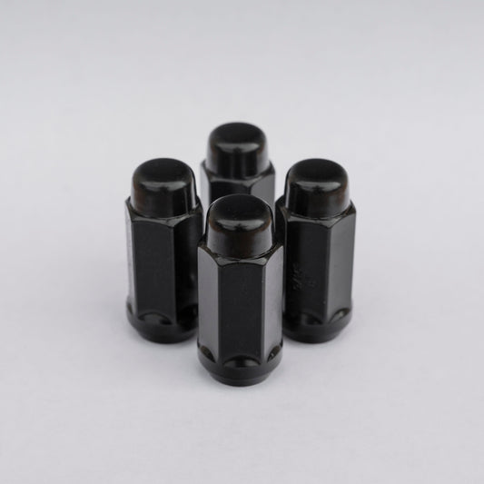 RAM 2500/3500 Black Closed Top Lug Nuts against light gray background.